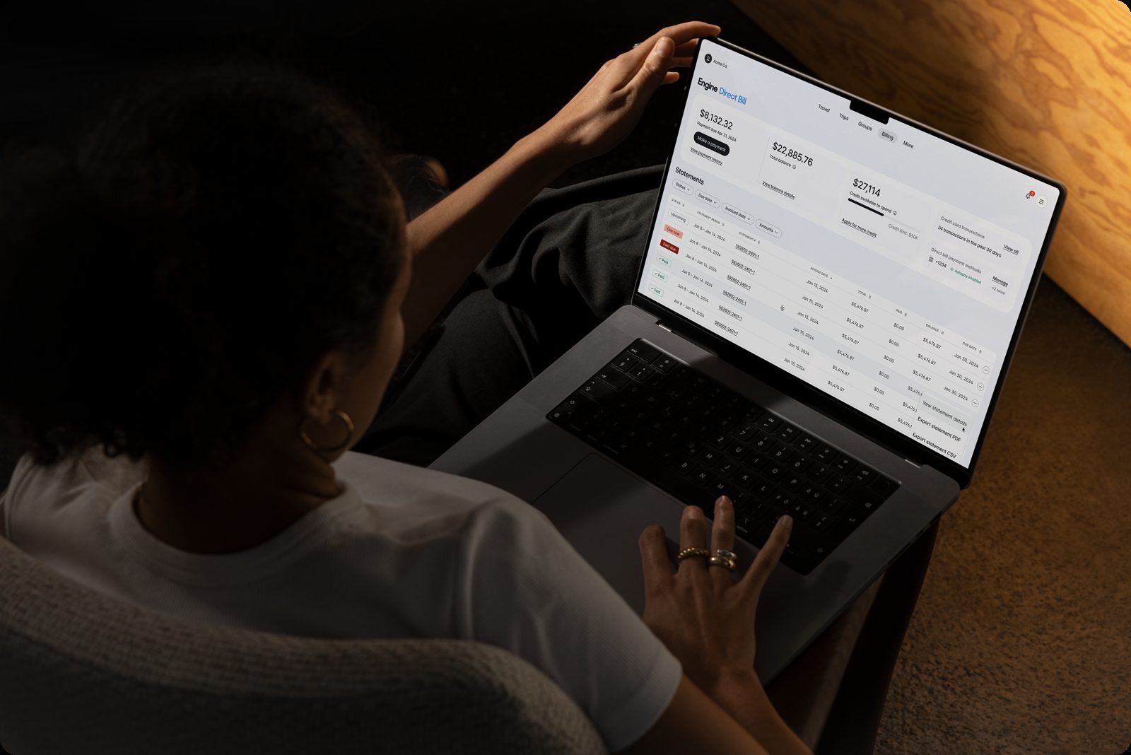 Person reviewing the Engine Direct Bill dashboard, with statement balance, total balance, and invoice rows