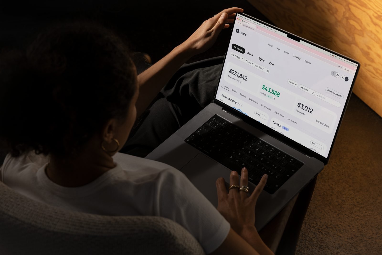 Engine Trends on a laptop, charting monthly hotel spend from January through August